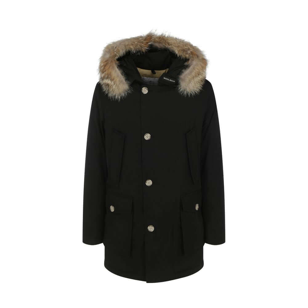 Woolrich Black Cotton Parka with fur hood, front zip closure, side pockets, iconic brand patch, and oversize fit for AW25 season.