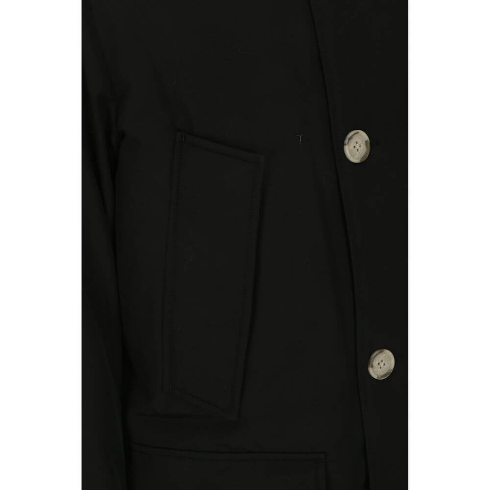 Close-up of Woolrich Black Cotton Parka with button details and side patch pocket.