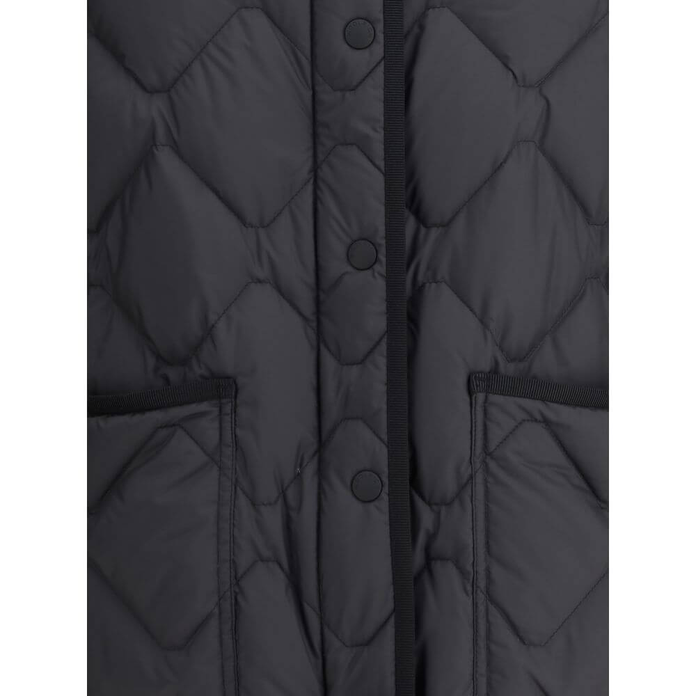 Close-up of Woolrich Black Polyester Clothing Heritage Down Jacket with snap closure, front patch pockets, and padded design.