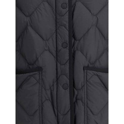 Close-up of Woolrich Black Polyester Clothing Heritage Down Jacket with snap closure, front patch pockets, and padded design.